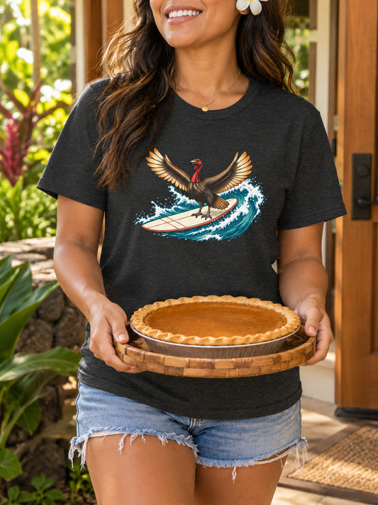 Hawaiian woman bringing pumpkin pie to a gathering in a dark gray surfing turkey Thanksgiving T-shirt.